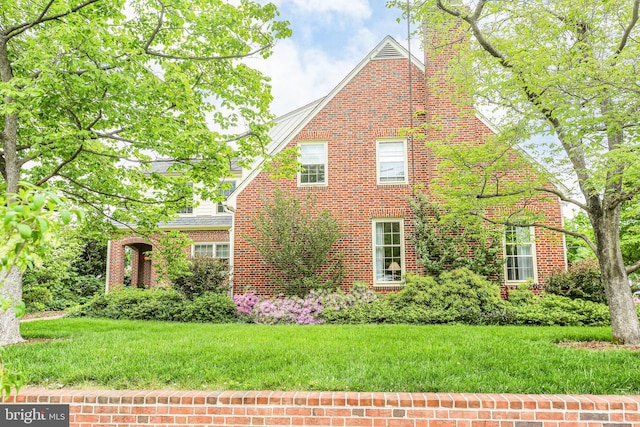 809 Cornell St, Fredericksburg, VA 22401 - view of property exterior featuring a chimney, a yard, and brick siding