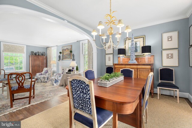 809 Cornell St, Fredericksburg, VA 22401 - dining space with arched walkways, an inviting chandelier, ornamental molding, and wood finished floors