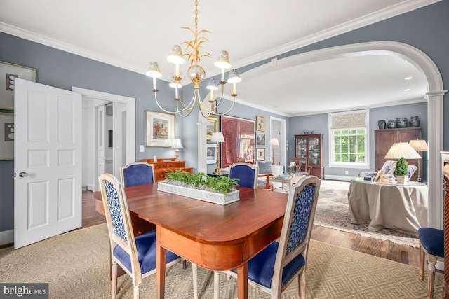 809 Cornell St, Fredericksburg, VA 22401 - dining space with ornamental molding, wood finished floors, baseboards, arched walkways, and a notable chandelier