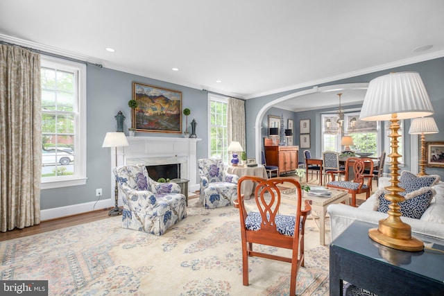 809 Cornell St, Fredericksburg, VA 22401 - living area featuring baseboards, ornamental molding, a healthy amount of sunlight, and wood finished floors