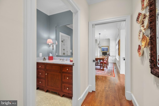 809 Cornell St, Fredericksburg, VA 22401 - bathroom with crown molding, baseboards, wood finished floors, and vanity