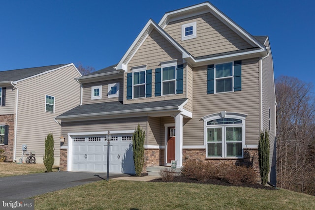 craftsman house featuring aphalt driveway, a front yard, stone siding, and an attached garage