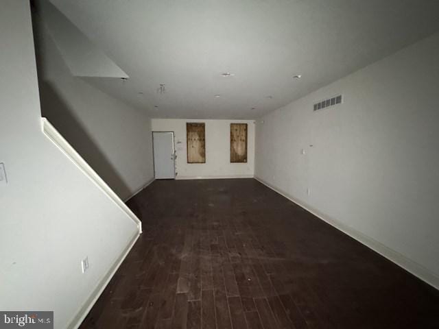 unfurnished living room with visible vents and wood finished floors