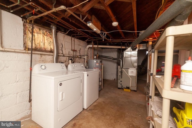 laundry area with laundry area, water heater, heating unit, and separate washer and dryer