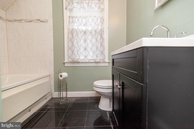 full bathroom featuring a bathing tub, baseboards, toilet, and tile patterned floors