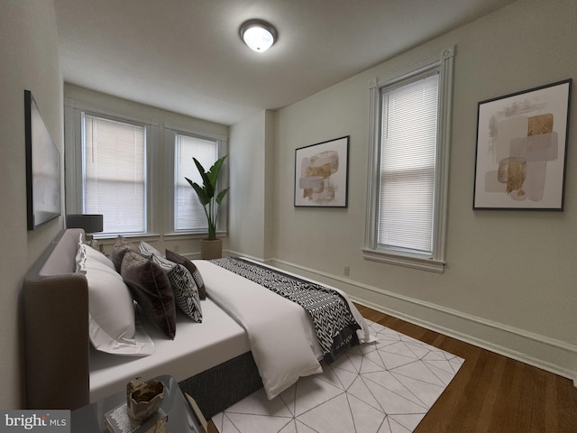 bedroom featuring baseboards and wood finished floors