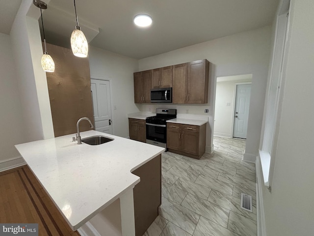 kitchen featuring visible vents, marble finish floor, stainless steel appliances, light countertops, and a sink