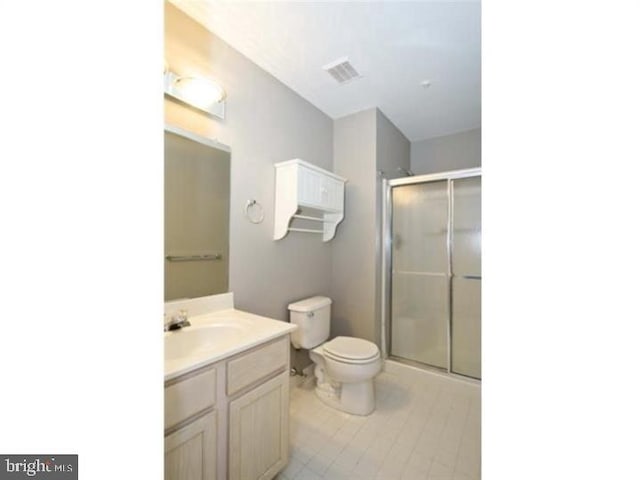 full bath featuring a stall shower, visible vents, vanity, and toilet