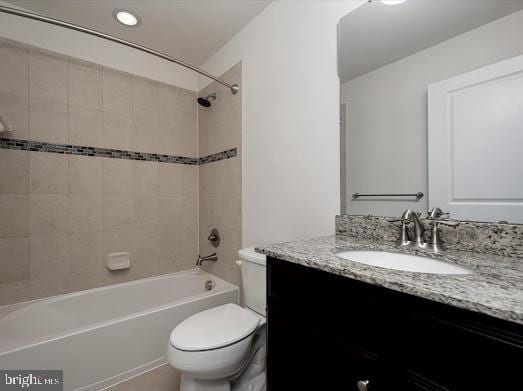 full bathroom with shower / washtub combination, vanity, and toilet