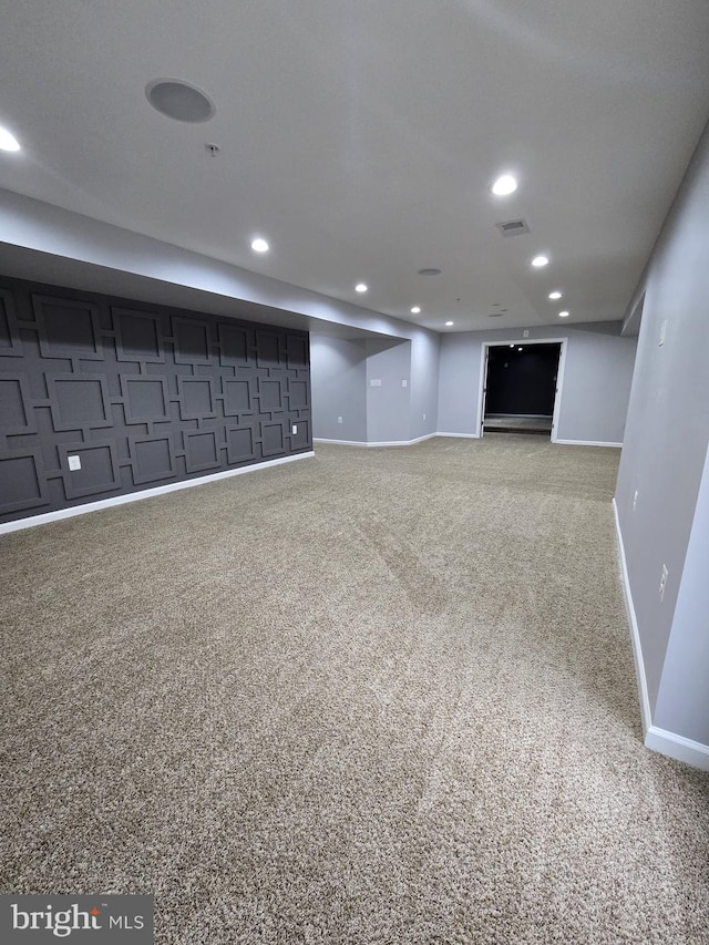 finished basement featuring baseboards, carpet flooring, visible vents, and recessed lighting