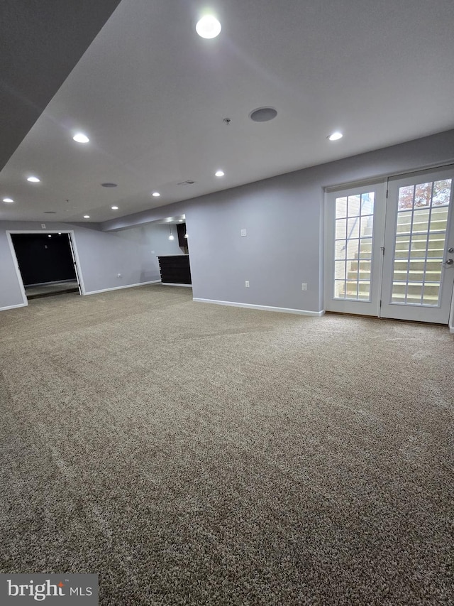 unfurnished living room featuring recessed lighting, carpet flooring, and baseboards