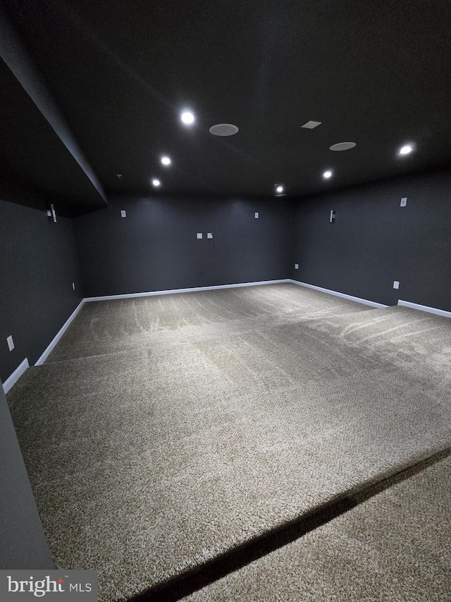 empty room with baseboards, carpet flooring, and recessed lighting