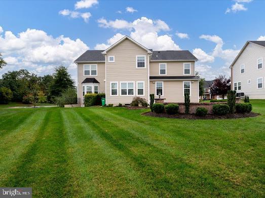 back of property featuring a lawn