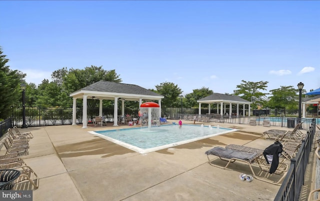 pool featuring fence, a gazebo, and a patio