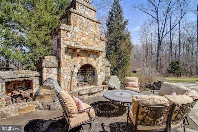 view of patio / terrace with an outdoor living space with a fireplace