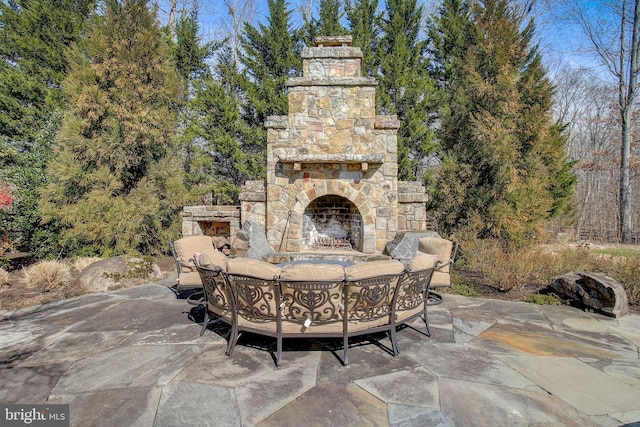 view of patio with an outdoor living space with a fireplace