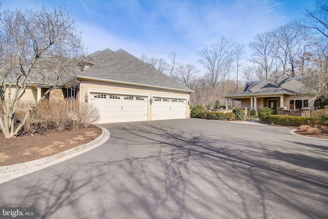 view of property exterior with aphalt driveway and stucco siding