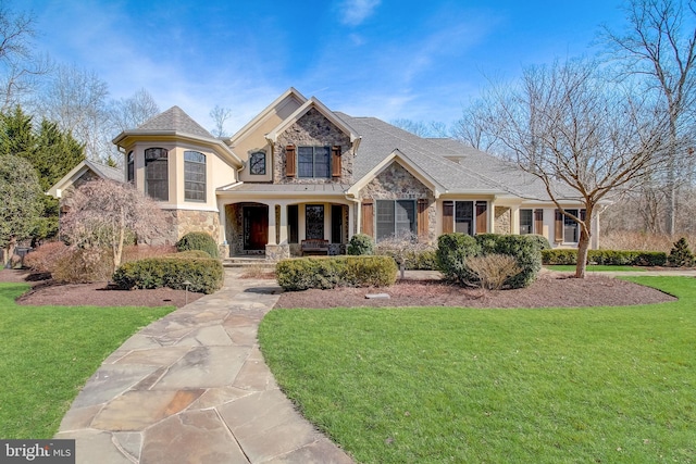 view of front of property with stone siding and a front yard