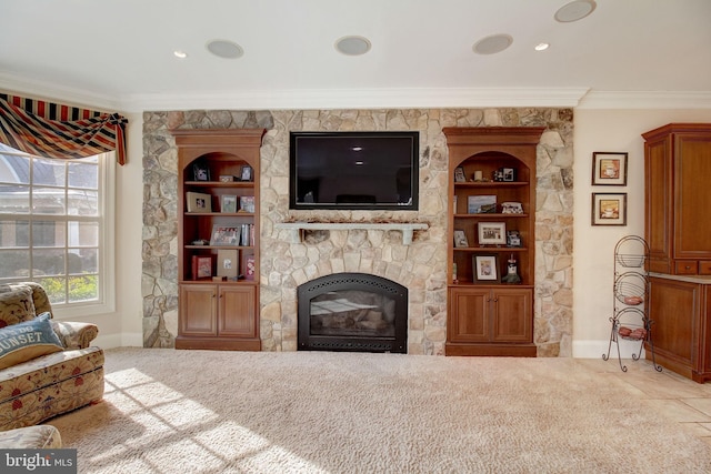 carpeted living area with built in shelves, baseboards, a fireplace, and crown molding