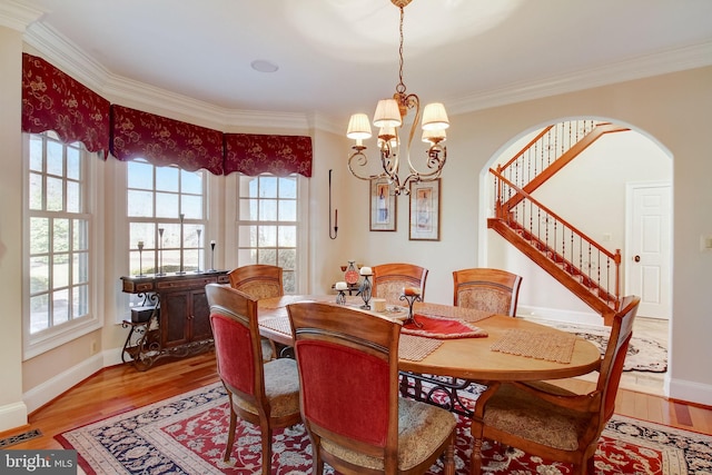 dining area with a notable chandelier, light wood-style flooring, and a wealth of natural light