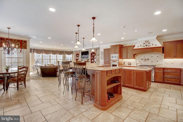 kitchen with decorative backsplash, a large island, custom range hood, appliances with stainless steel finishes, and crown molding