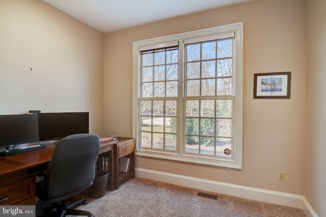 office area featuring baseboards, carpet floors, visible vents, and a healthy amount of sunlight