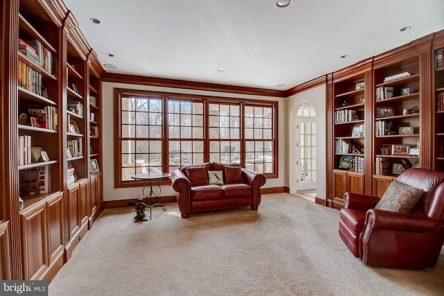 living area featuring built in shelves, carpet, recessed lighting, ornamental molding, and baseboards