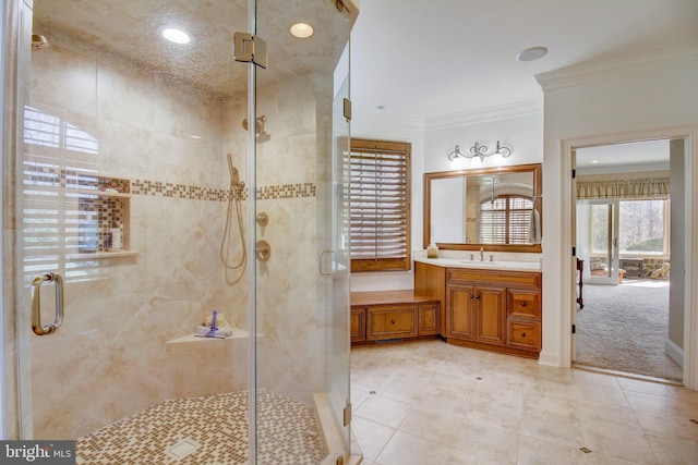 full bath with ornamental molding and a shower stall