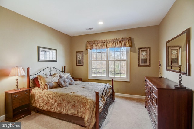 bedroom featuring baseboards, visible vents, and light colored carpet