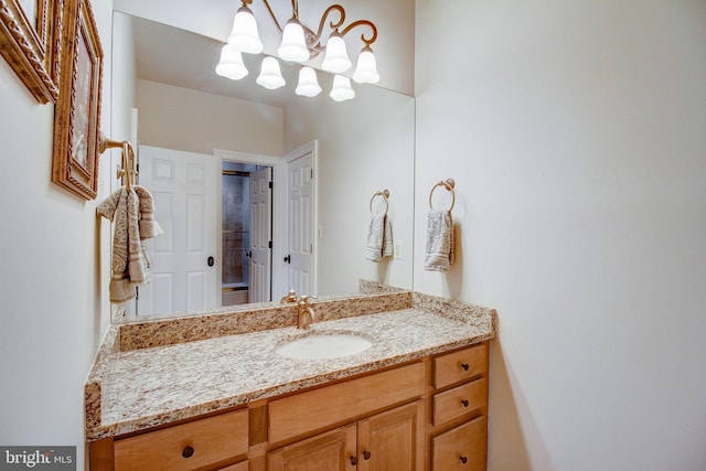 bathroom featuring vanity and a notable chandelier