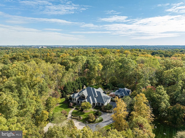 drone / aerial view featuring a forest view