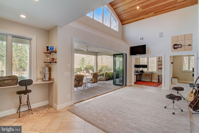 doorway featuring light tile patterned floors, recessed lighting, high vaulted ceiling, wooden ceiling, and baseboards