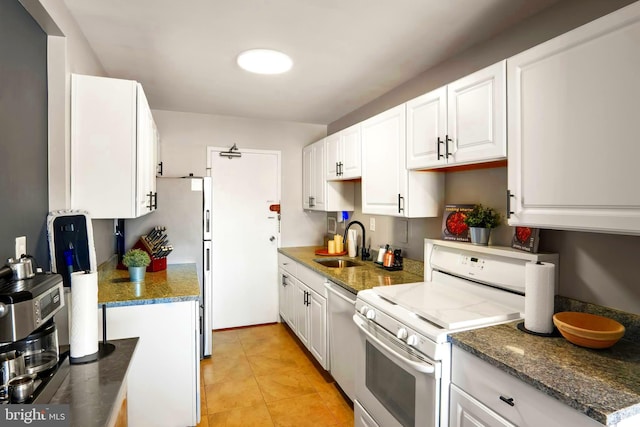 kitchen with light tile patterned floors, dishwashing machine, a sink, white cabinets, and electric stove