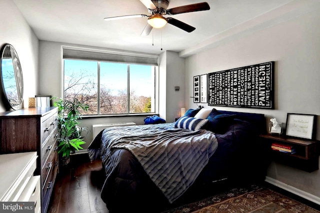 bedroom featuring ceiling fan, dark wood finished floors, and baseboards