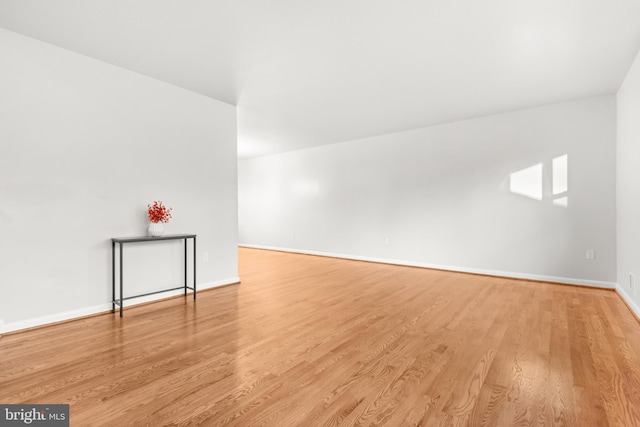 interior space featuring baseboards and wood finished floors