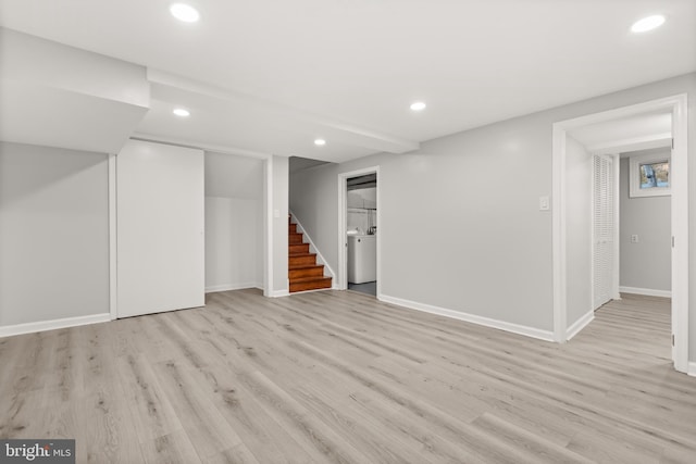 finished basement featuring baseboards, stairway, light wood-style flooring, and recessed lighting