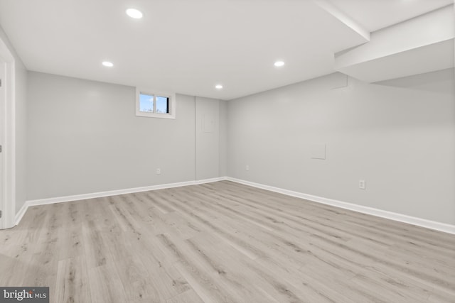 basement with baseboards, wood finished floors, and recessed lighting