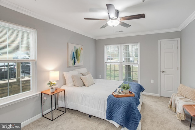 bedroom featuring ceiling fan, carpet floors, visible vents, baseboards, and crown molding