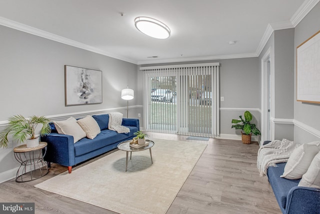 living room with baseboards, wood finished floors, and crown molding