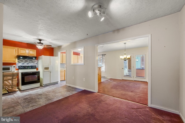 kitchen featuring light carpet, white appliances, under cabinet range hood, backsplash, and ceiling fan with notable chandelier