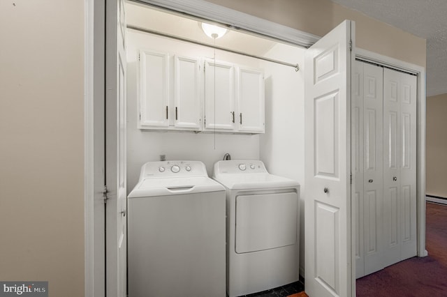 washroom with a baseboard heating unit, dark carpet, washing machine and clothes dryer, and cabinet space