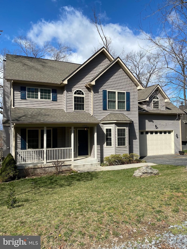 view of front facade featuring driveway, an attached garage, a porch, and a front lawn