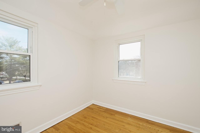 empty room with light wood-type flooring and baseboards