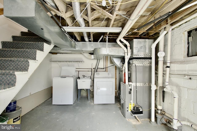 unfinished basement with independent washer and dryer, stairway, and a sink