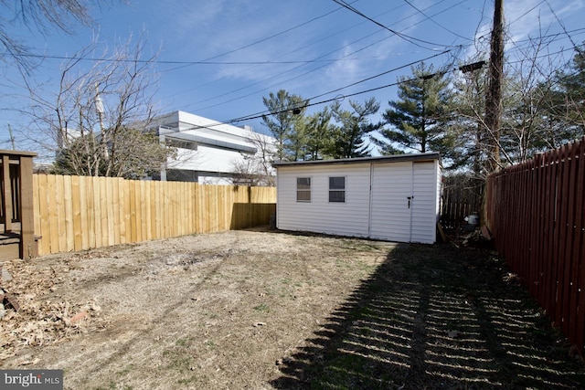 view of yard with an outbuilding and a fenced backyard