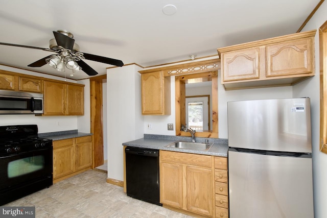 kitchen featuring dark countertops, a sink, black appliances, ceiling fan, and baseboards