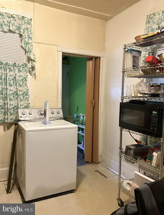 clothes washing area featuring washer / dryer and laundry area