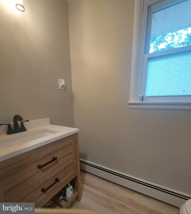 bathroom featuring vanity and baseboard heating