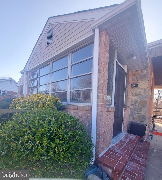 view of side of property featuring brick siding