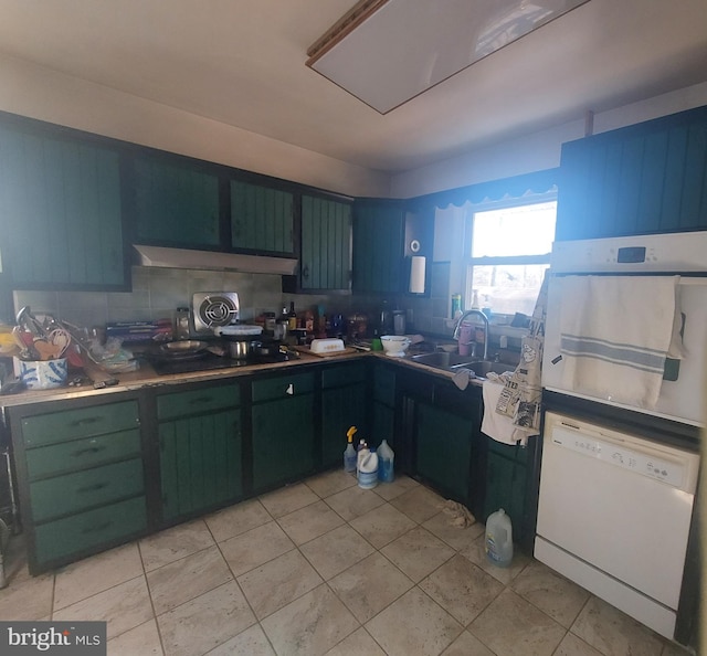 kitchen with oven, dishwasher, decorative backsplash, light tile patterned flooring, and a sink